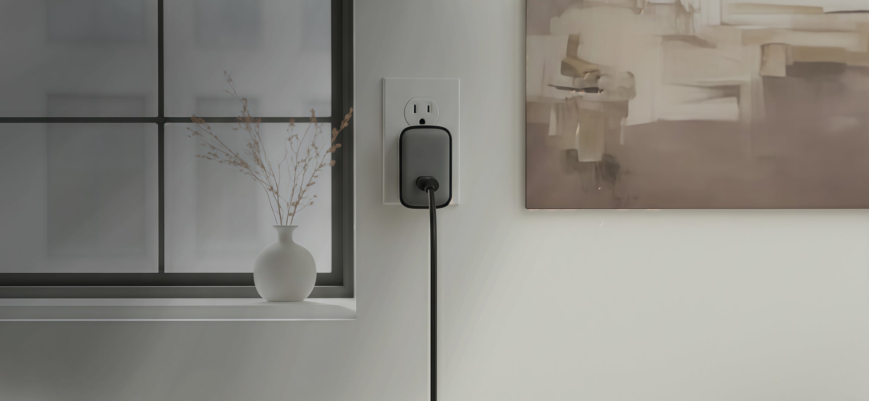 Schlüssel wall charger plugged into a power outlet in a modern minimalist interior